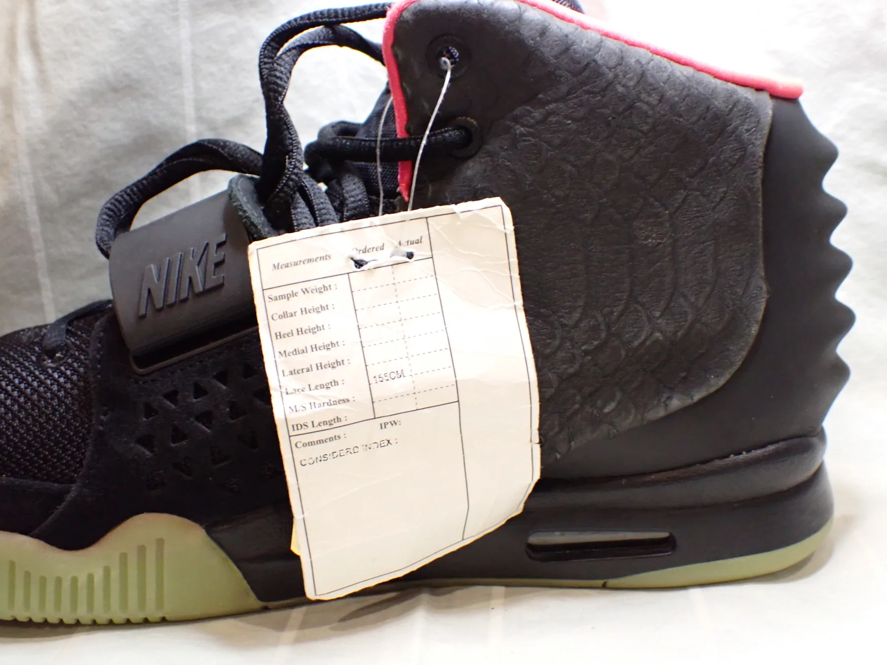 Nike Air Yeezy 2 Solar Red sample photographed with factory document